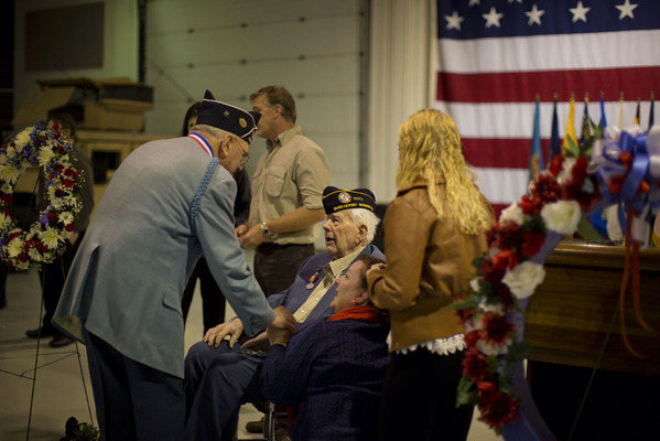 Two veterans talk after Veterans Day ceremony.