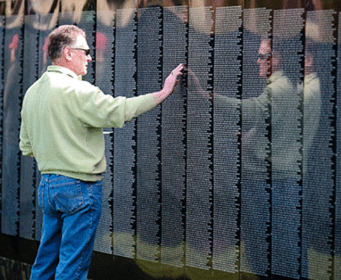 Elderly gentleman touching the World War II Memorial.