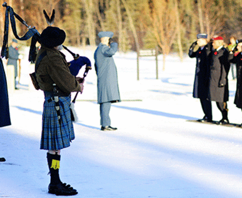 Bagpiper playing at military honors funeral.